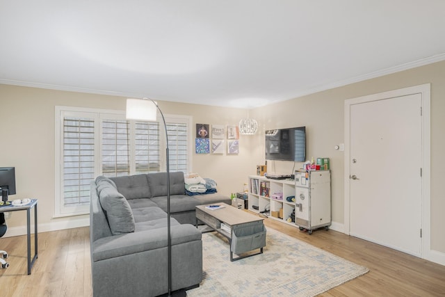 living room featuring ornamental molding and light wood-type flooring