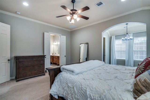 carpeted bedroom featuring ensuite bath, ceiling fan with notable chandelier, and ornamental molding