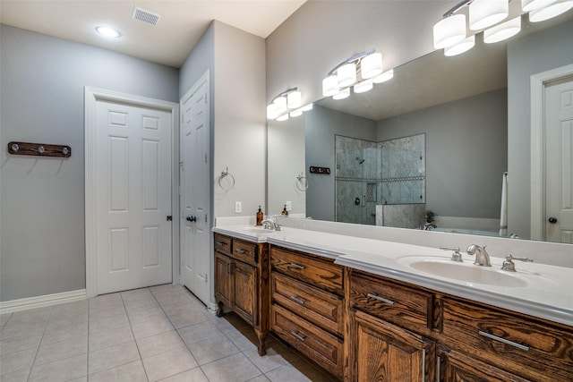 bathroom featuring vanity, independent shower and bath, and tile patterned flooring