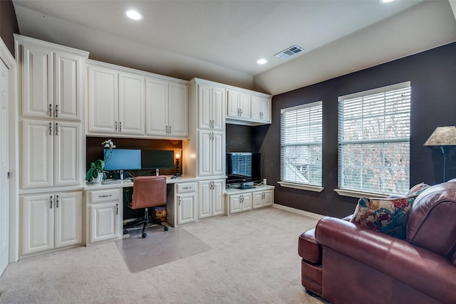 office with light colored carpet and built in desk