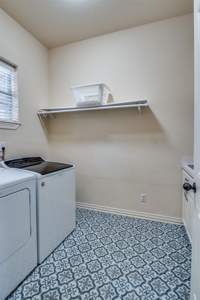 clothes washing area with cabinets and independent washer and dryer