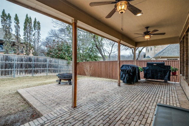 view of patio / terrace with grilling area, ceiling fan, and an outdoor fire pit