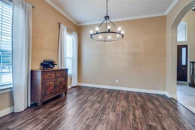 dining area with crown molding, an inviting chandelier, and dark wood-type flooring