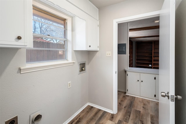 clothes washing area featuring cabinets, electric dryer hookup, washer hookup, and dark hardwood / wood-style flooring