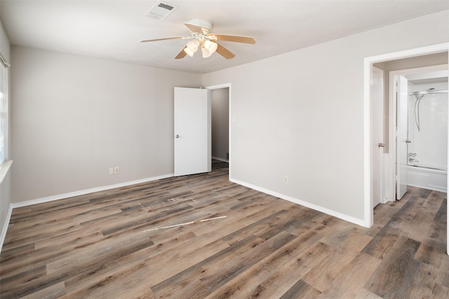 empty room featuring dark hardwood / wood-style flooring and ceiling fan