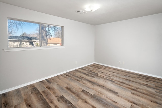 spare room with hardwood / wood-style flooring