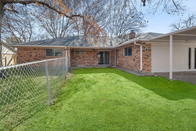 rear view of house with a yard