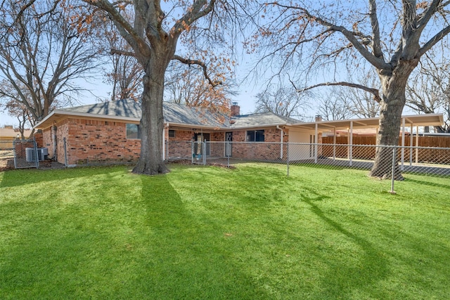 rear view of property with a yard and central air condition unit