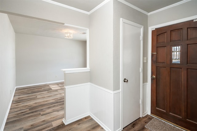 entryway with crown molding and hardwood / wood-style flooring