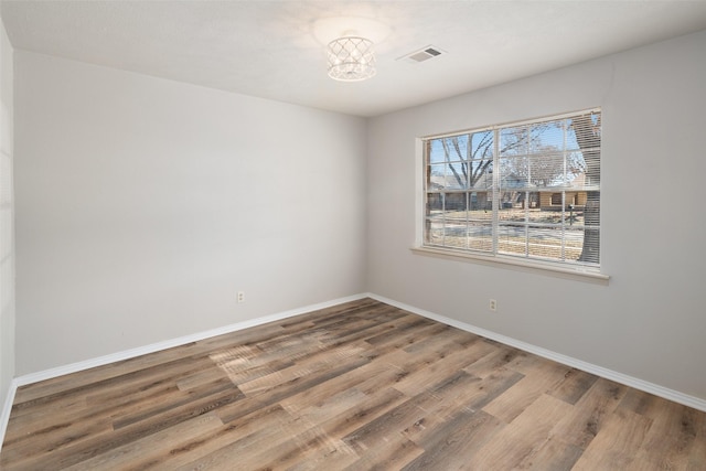 unfurnished room with hardwood / wood-style floors