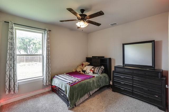 carpeted bedroom featuring ceiling fan