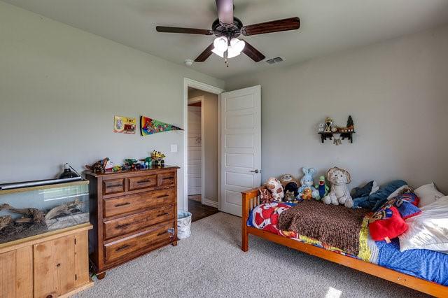 carpeted bedroom with ceiling fan