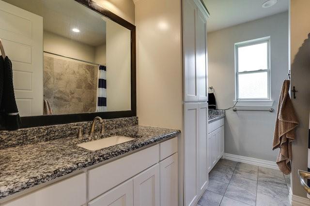 bathroom with vanity and curtained shower