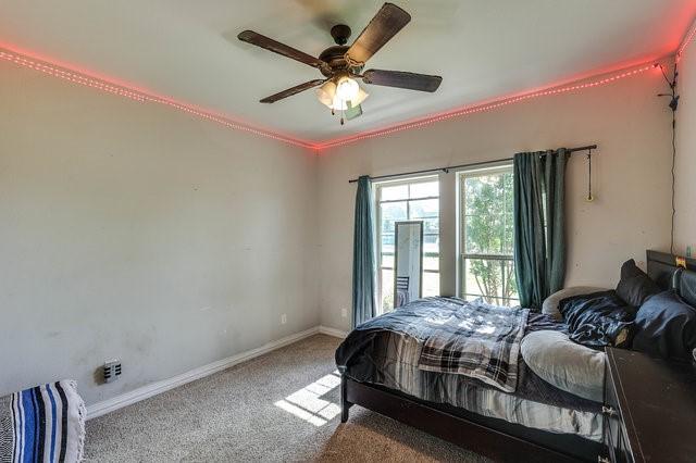 carpeted bedroom featuring ceiling fan