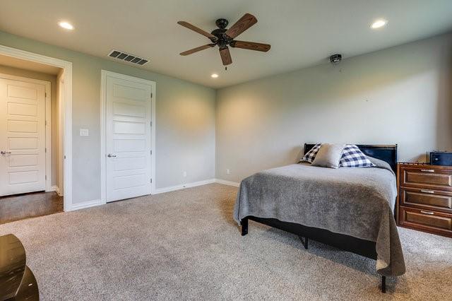 carpeted bedroom with ceiling fan