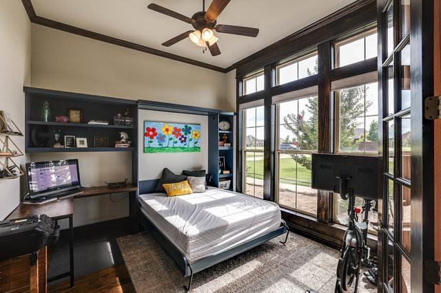 bedroom featuring ornamental molding and wood-type flooring