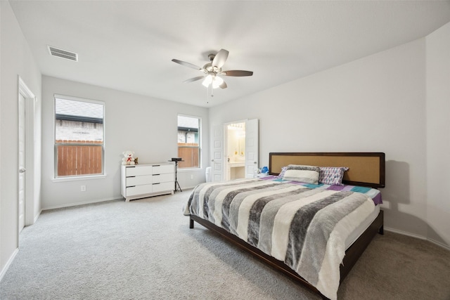 carpeted bedroom with connected bathroom and ceiling fan