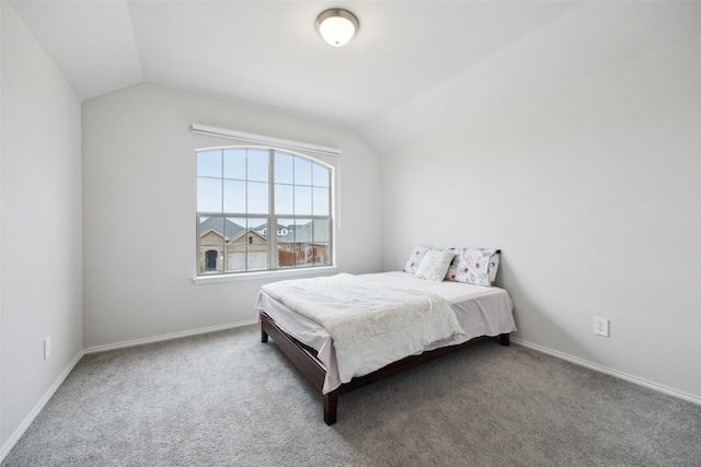 carpeted bedroom with vaulted ceiling