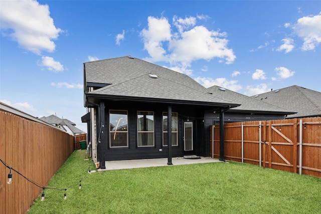 back of house with a yard and a patio area