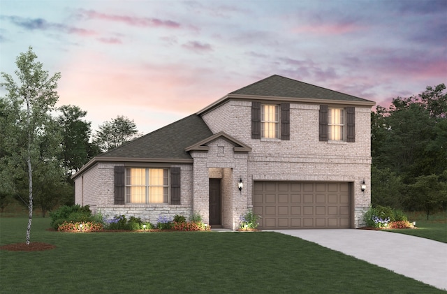 view of front of home featuring a garage and a lawn