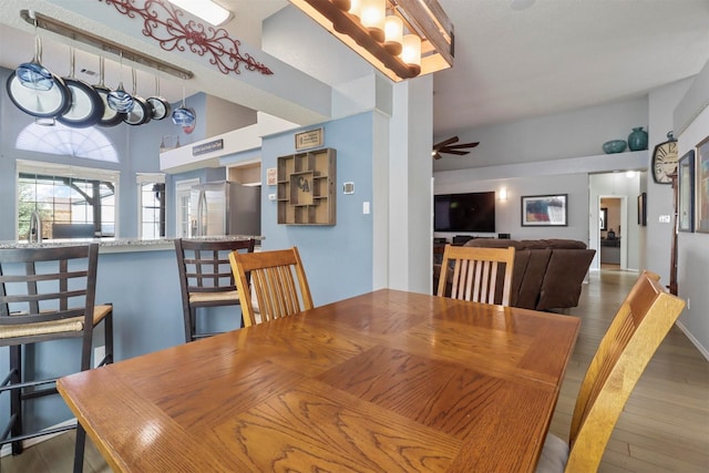 dining room with a ceiling fan and wood finished floors