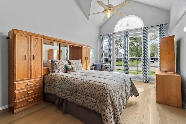 bedroom with vaulted ceiling, wood finished floors, and a ceiling fan