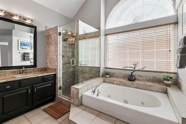 full bath featuring lofted ceiling, tile patterned flooring, vanity, a jetted tub, and a shower stall