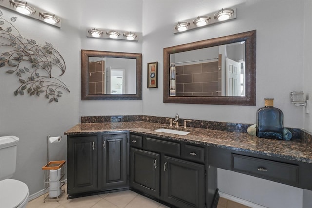 full bath with a shower with shower curtain, vanity, toilet, and tile patterned floors