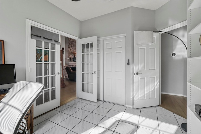 interior space featuring french doors and light tile patterned floors