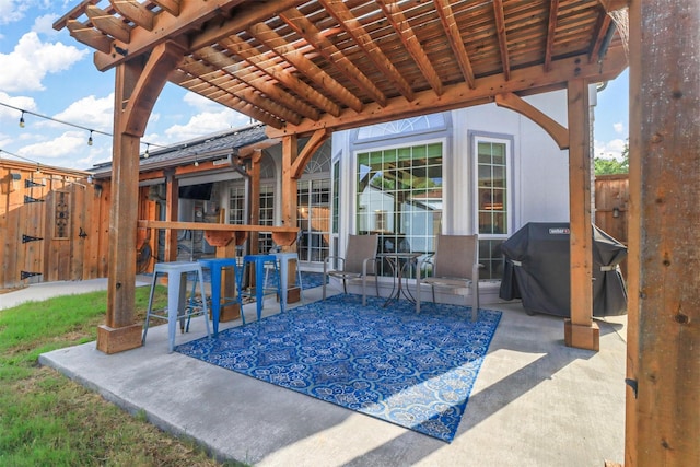 view of patio featuring fence and area for grilling