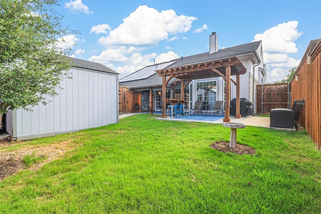 rear view of property with a yard, an outdoor structure, a fenced backyard, and a pergola