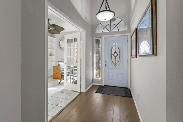 foyer featuring baseboards and hardwood / wood-style floors