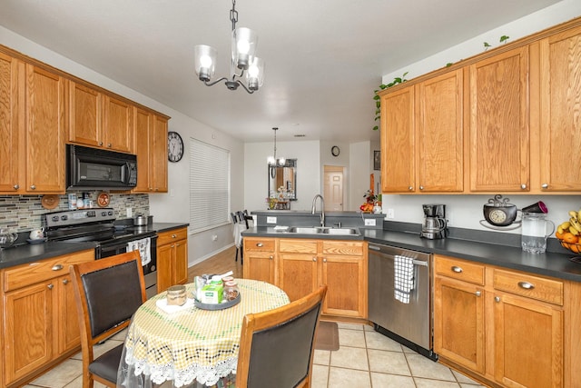 kitchen with appliances with stainless steel finishes, sink, an inviting chandelier, and decorative light fixtures