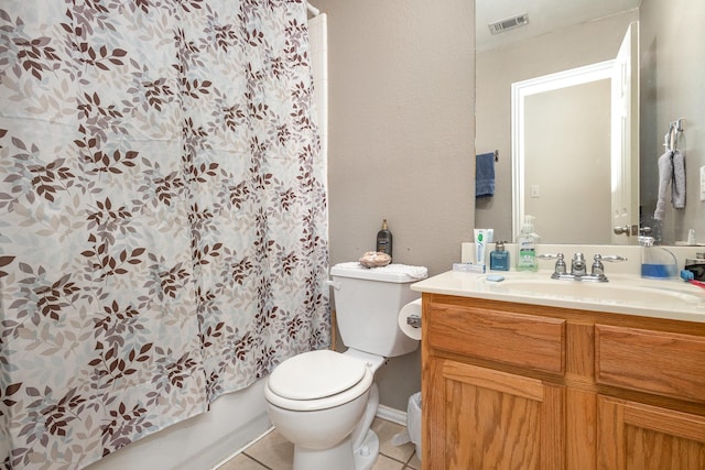 bathroom with tile patterned flooring, vanity, and toilet