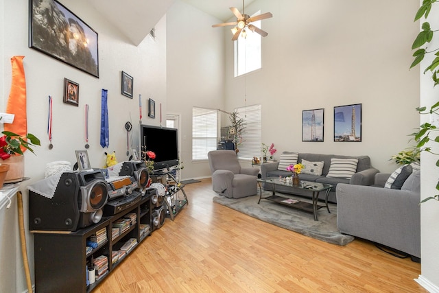 living room featuring ceiling fan and light wood-type flooring