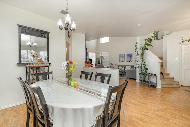 dining area featuring an inviting chandelier and light wood-type flooring