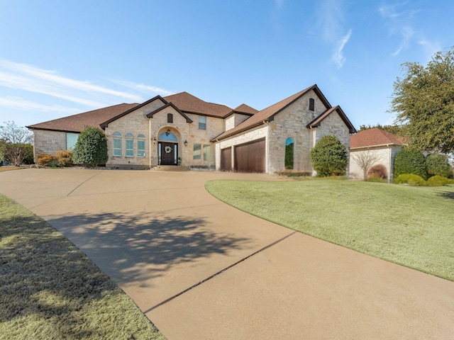 view of front facade with a garage and a front lawn