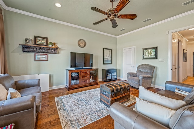 living room with crown molding, ceiling fan, and hardwood / wood-style floors