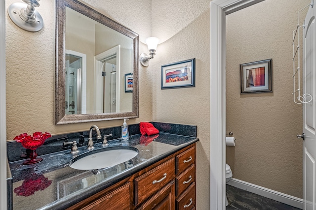 bathroom featuring vanity and toilet