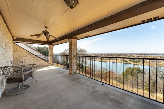 view of patio / terrace featuring ceiling fan and a water view