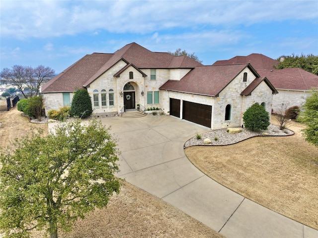 french provincial home with a garage