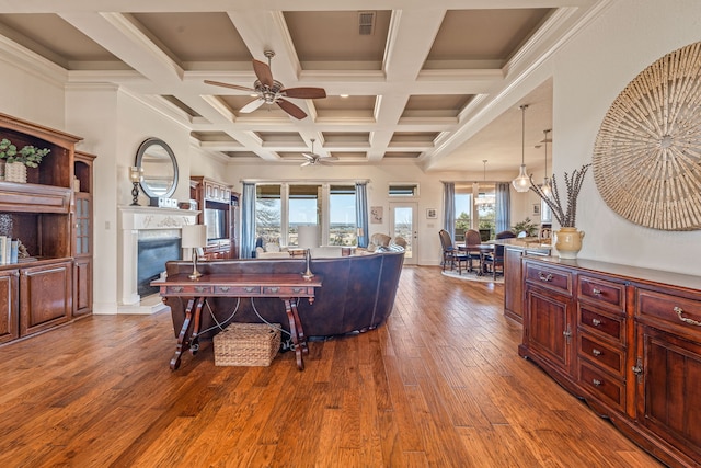 living room with hardwood / wood-style flooring, coffered ceiling, ceiling fan, and beamed ceiling