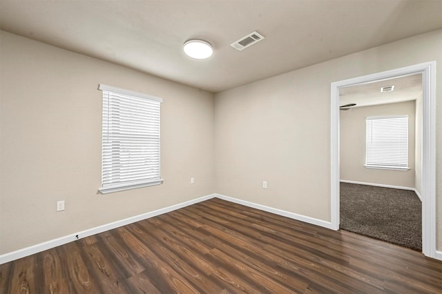 empty room with dark wood-type flooring