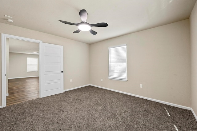 carpeted spare room with ceiling fan