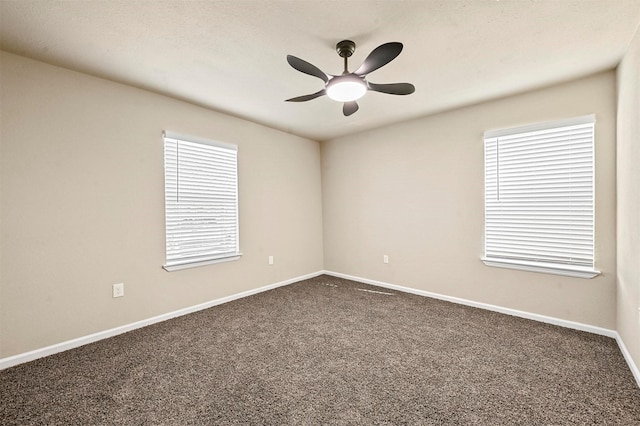 carpeted spare room featuring ceiling fan