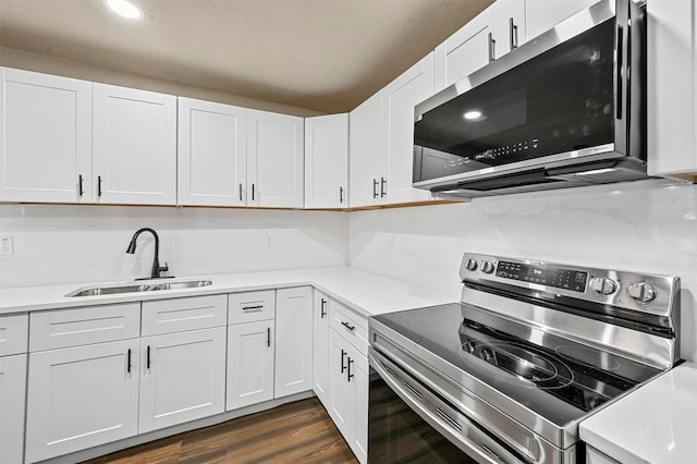 kitchen featuring white cabinetry, sink, dark hardwood / wood-style flooring, and stainless steel appliances