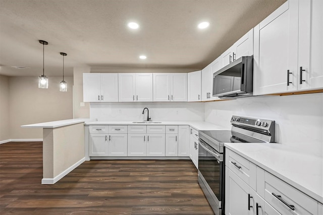 kitchen featuring sink, white cabinetry, hanging light fixtures, kitchen peninsula, and stainless steel appliances