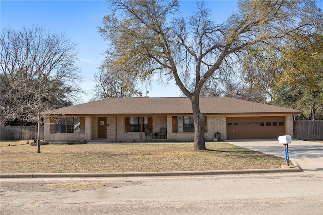 ranch-style home featuring a garage and a front yard