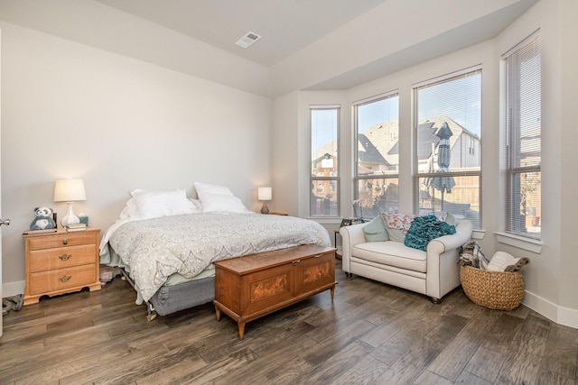 bedroom with dark hardwood / wood-style floors