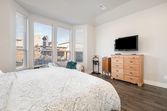 bedroom with dark wood-type flooring